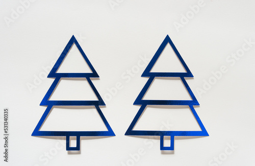 two metallic blue foil holiday trees on a white background