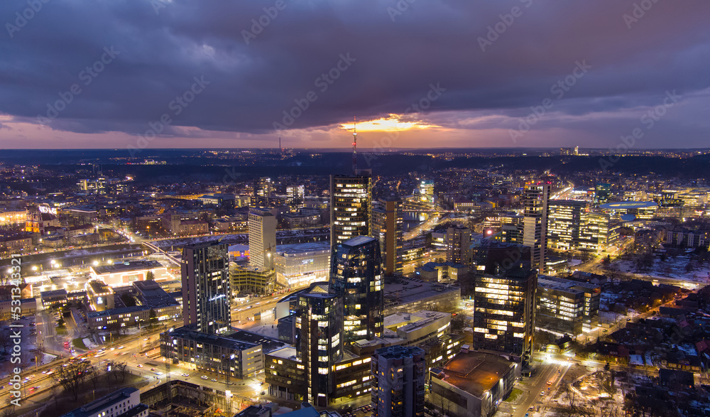 Beautiful aerial evening view of illuminated business district in Vilnius, Lithuania.