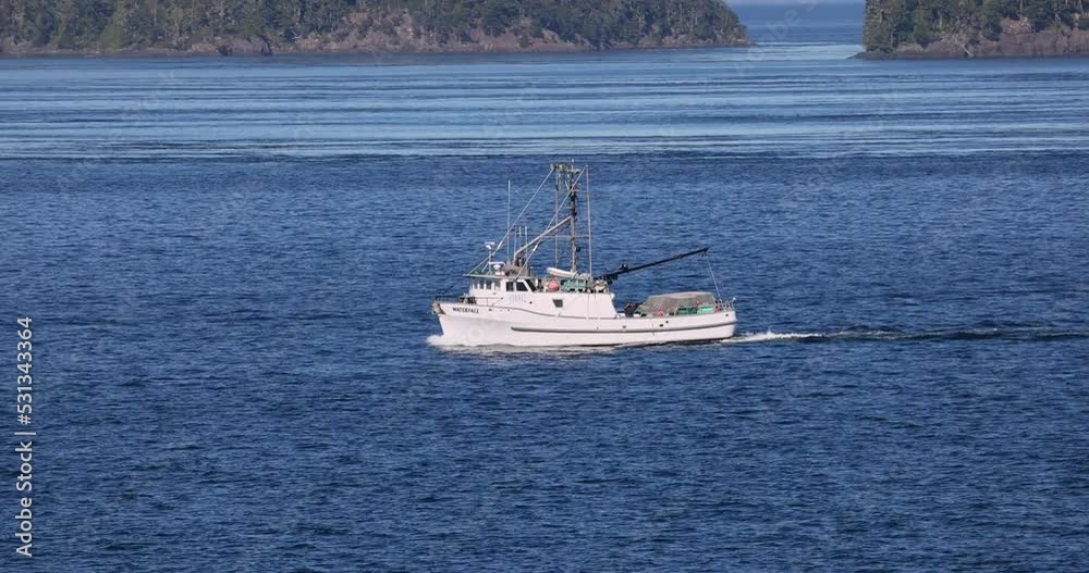 Fishing boat island inside passage Ketchikan Alaska. Coastal route for ships and boats. Network of island and channels. Prime fishing, boating and cruise ship destination. Fishing boat island inside passage Ketchikan Alaska. Coastal route for ships and boats. Network of island and channels. Prime fishing, boating and cruise ship destination.