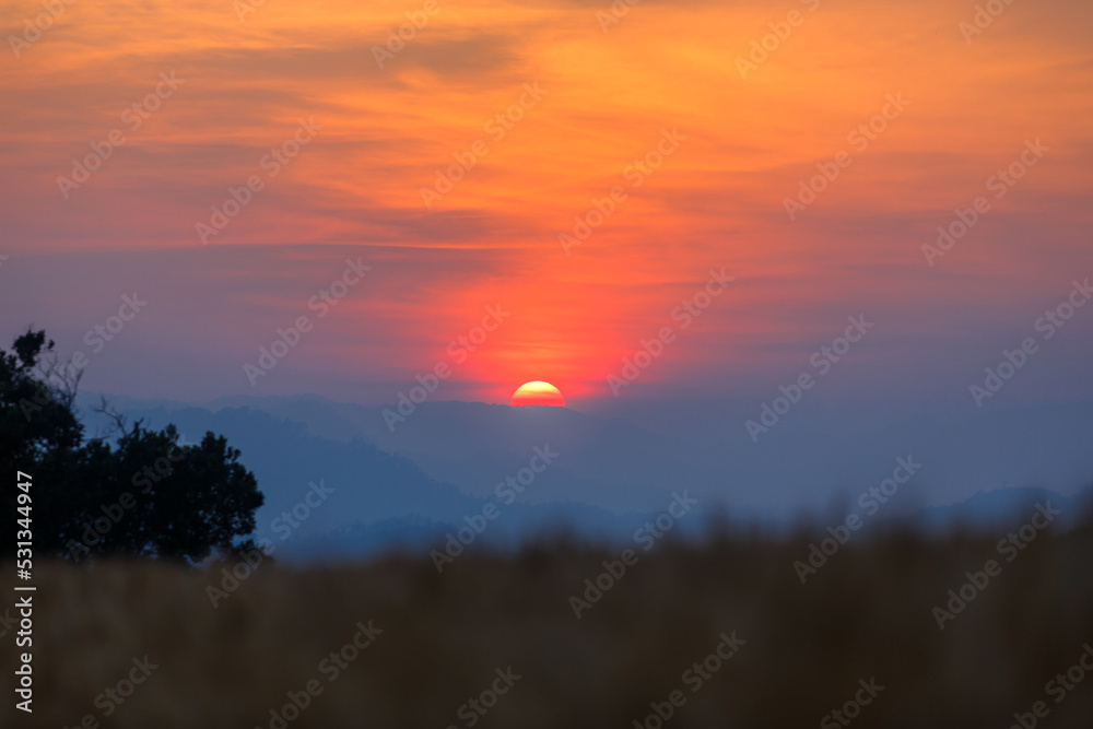 Majestic dramtic sunset sky over the mountains landscape