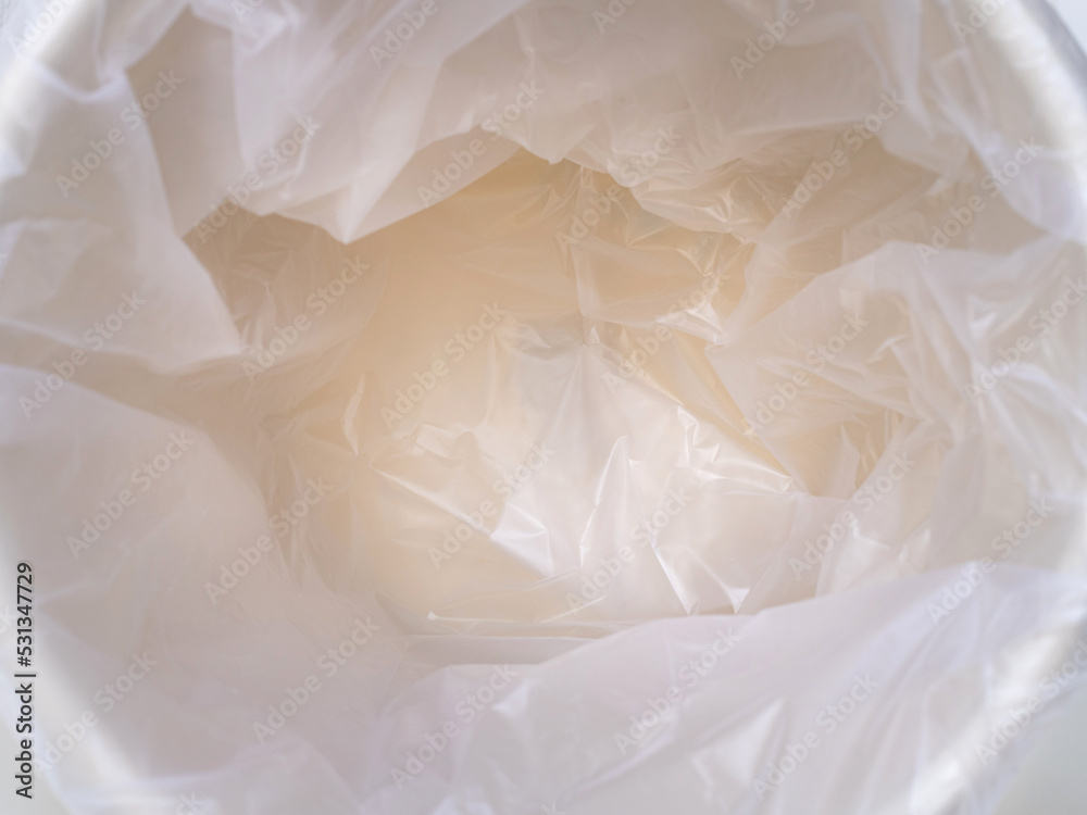 Empty trash container or bin with white plastic bag Empty trash container or bin with white plastic bag