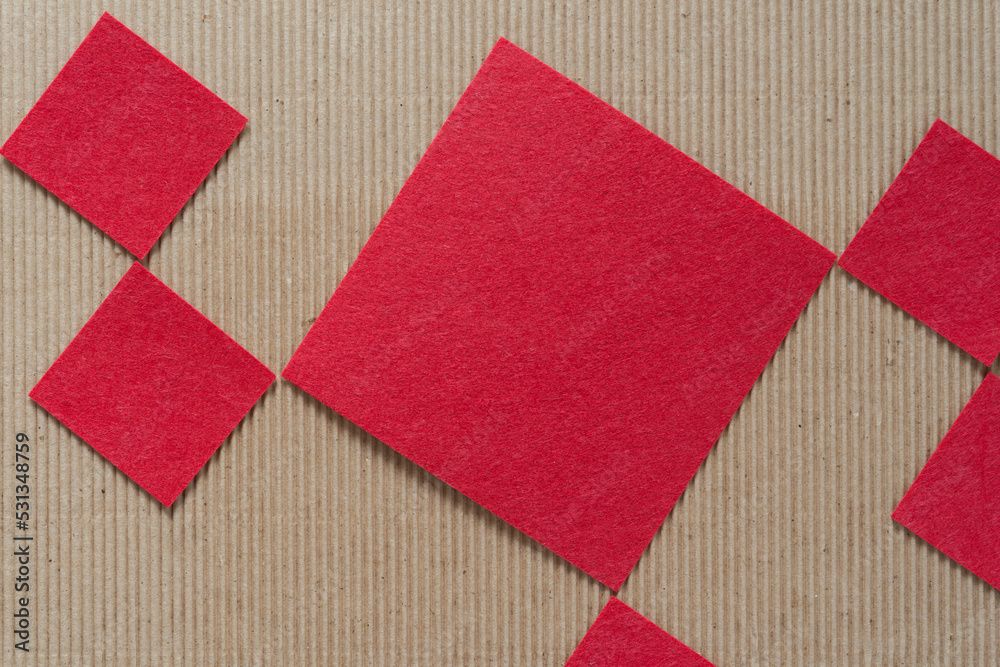 red felt shapes on corrugated paper red felt shapes on corrugated paper