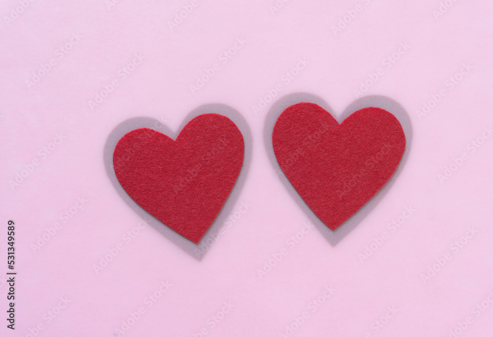 two felt heart with shadowy border on pink