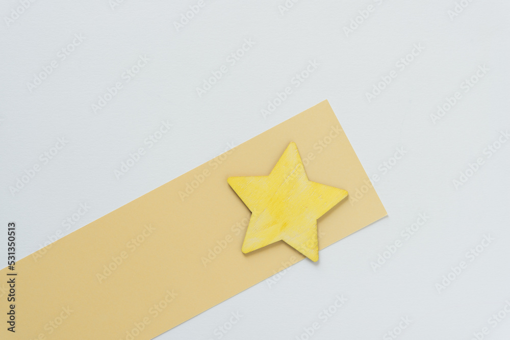 grungy wooden star painted yellow on yellow and white paper grungy wooden star painted yellow on yellow and white paper