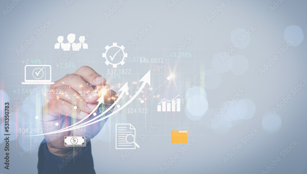A man touching on growth a graph virtual screen on hand to analyze for an investment of corporate. Business, and Finance concept. Analysis, strategy, and planning for business profit goals. A man touching on growth a graph virtual screen on hand to analyze for an investment of corporate. Business, and Finance concept. Analysis, strategy, and planning for business profit goals.