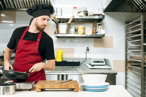 Chef works in kitchen of re...