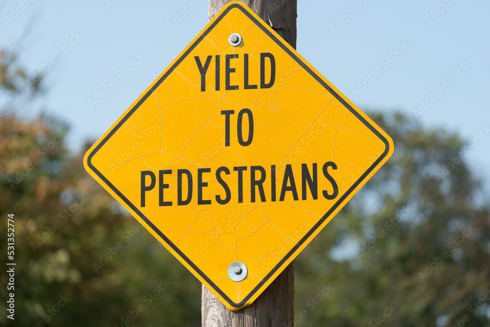 yield to pedestrians - road sign fixed to a pole