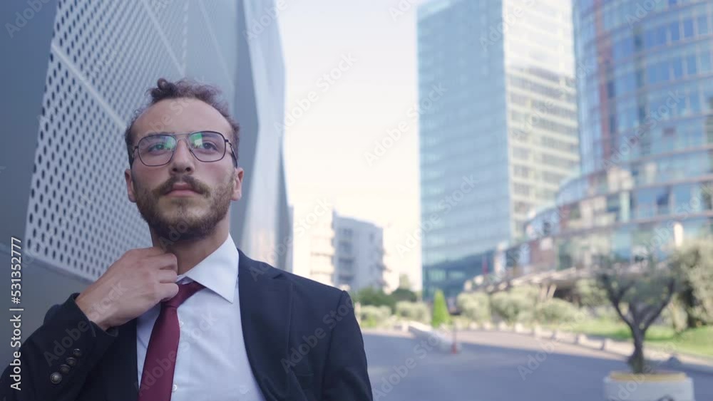 Businessman walking between luxury buildings.
He walks, straightening his shirt, tie, and jacket.
Businessman walking between luxury buildings.
He walks, straightening his shirt, tie, and jacket.