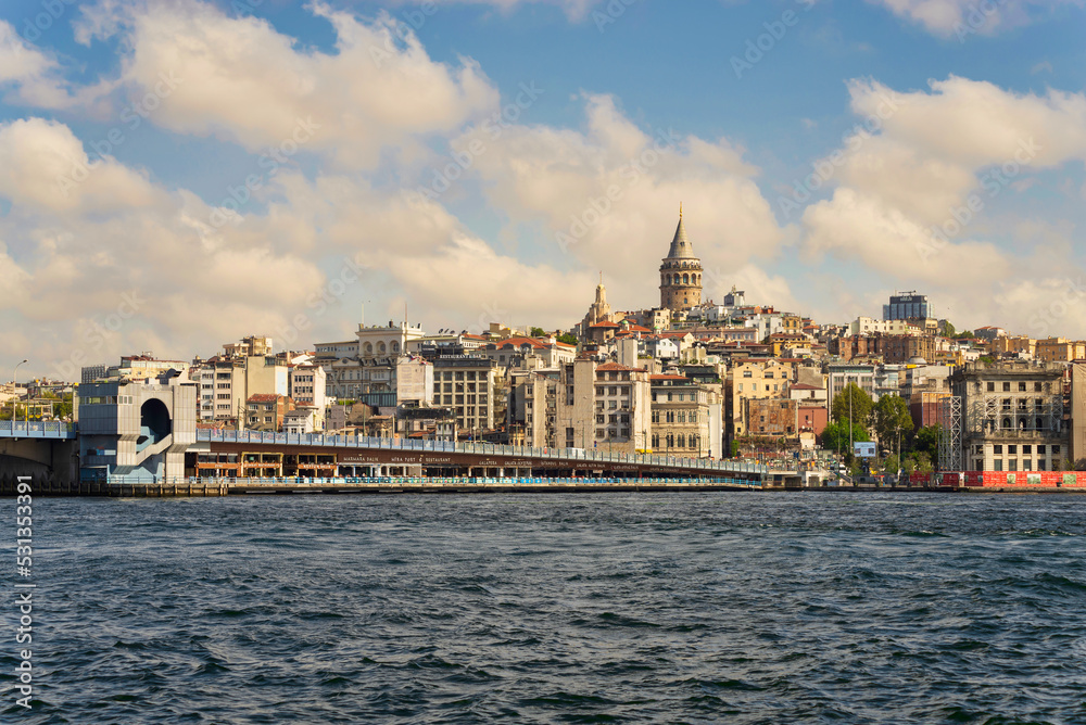 City view of Istanbul skyline, Turkey, from the Bosporous overlooking Galata Bridge with traditional fish restaurants and Galata Tower in the background
