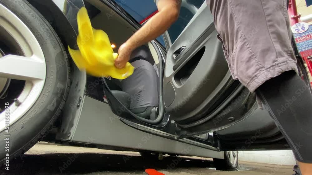 Male Doing Car Detailing On Passenger Side Of Car - Wiping Down Doors And Windows Male Doing Car Detailing On Passenger Side Of Car - Wiping Down Doors And Windows