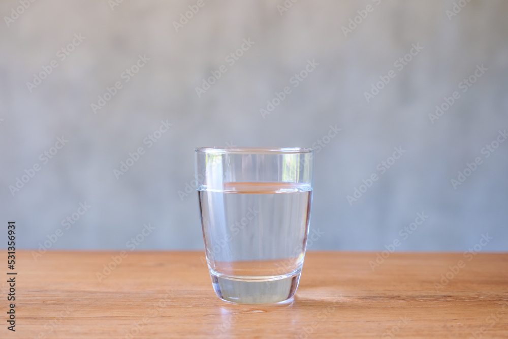 A glass of drinking water on wooden table A glass of drinking water on wooden table