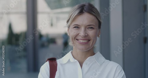 Portrait of Serious Mature Businesswoman Standing Look at Camera Outside Near Business Center. Successful Career Attractive Manager Feeling Confident. Slow Motion 