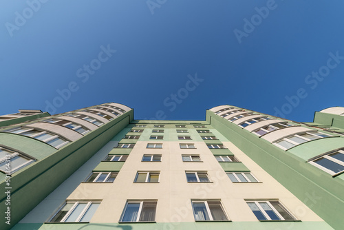 The wall of a high-rise building against the blue sky.