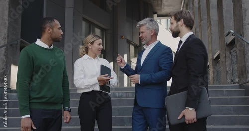 Business People Having Conversation Near Office On Street. Beautiful Smiling Coworkers Near Building. Business and Corporate Lifestyle Concept 