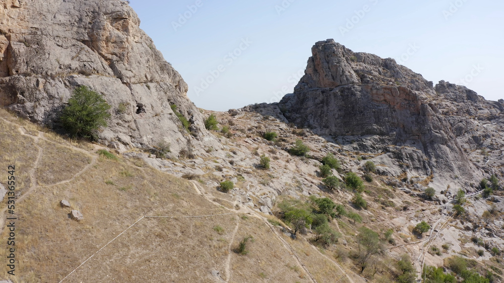 The desert surface of the sacred mountain of the city of Osh Sulaiman-Too. View of the amazing mountains.
