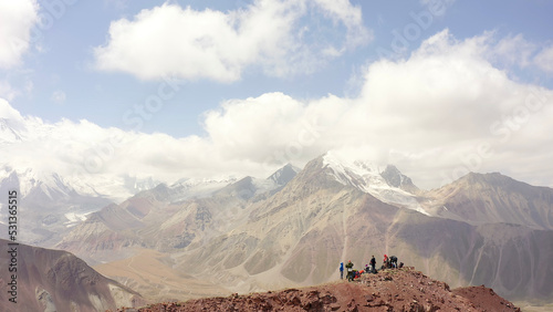 A group of tourists on the top of the mountain Red Katya. A long shot. Beautiful summer mountain landscape.