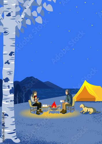 Young family and their dog enjoying night camp in autumn - Vertical