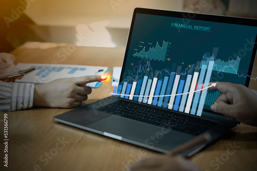 Businessman using laptop with analyzing forex trading graph financial data. business finance technology and investment concept. Stock Market Investments funds Business finance background.