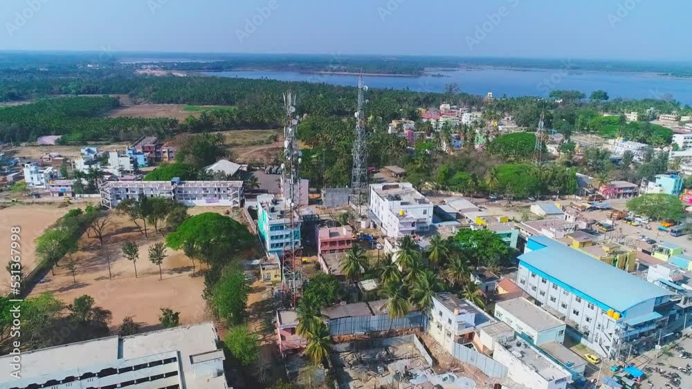 An aerial view of mobile towers amidst residential buildings An aerial view of mobile towers amidst residential buildings