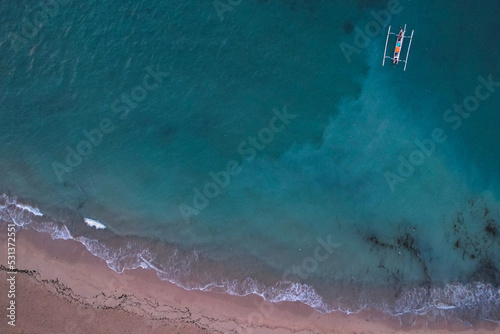 Birds eye view with a drone on beautiful turquoise ocean with boats - Bali