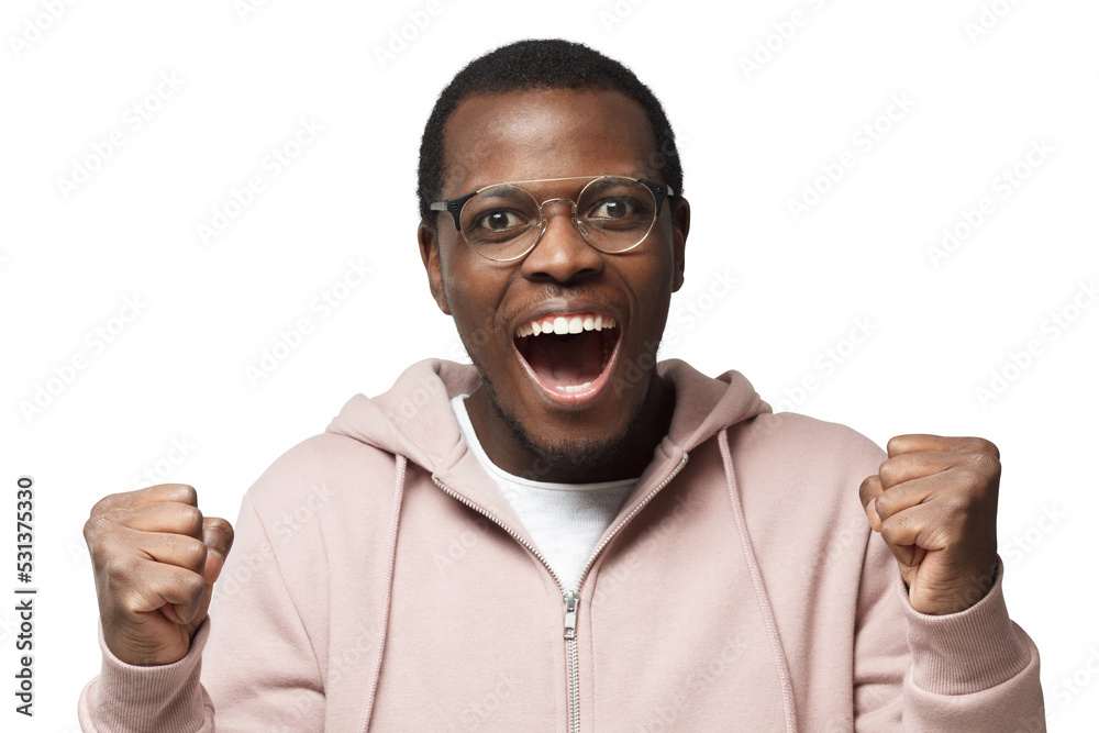 Young black male shouting while his team win, raised both fist in victory gesture, isolated Young black male shouting while his team win, raised both fist in victory gesture, isolated