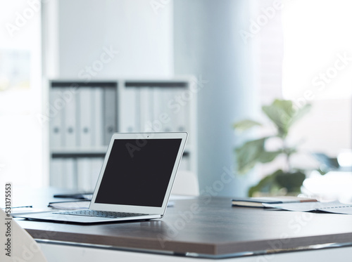 Empty office space and laptop or screen on a desk of software coding, cybersecurity and technology company or business. Creative SEO, social media and digital notebook at advertising marketing agency © Mumtaaz Dharsey/peopleimages.com