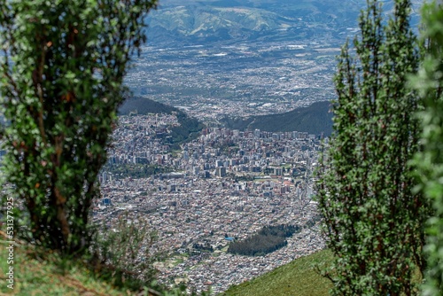 Beautiful scenery of a cityscape surrounded by mountains on sunny day in Quito, Ecuador