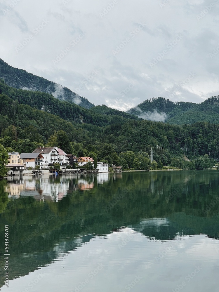 Picturesque view of lake with mountains and clouds reflections. Scenic idyllic calm landscape