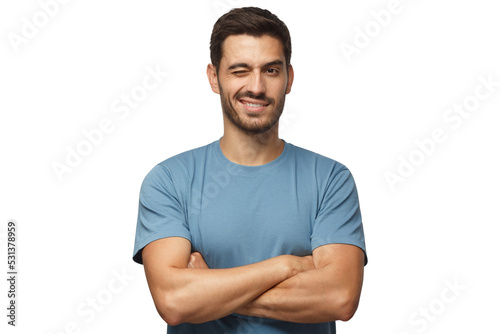 Canvastavla Handsome young man in blue t-shirt, with crossed arms smiling and winking, looki