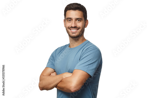 Smiling handsome young man in blue t-shirt standing with crossed arms