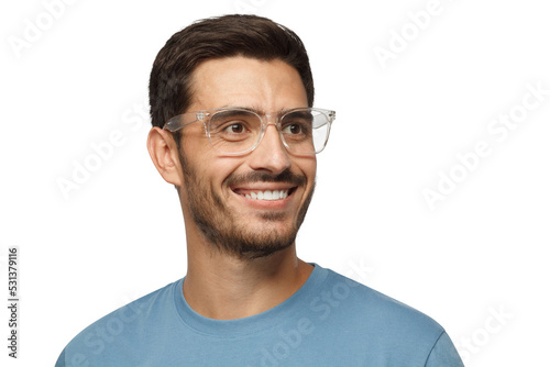 Close up portrait of smiling handsome male in blue t-shirt and transparent eyeglasses looking right © Damir Khabirov