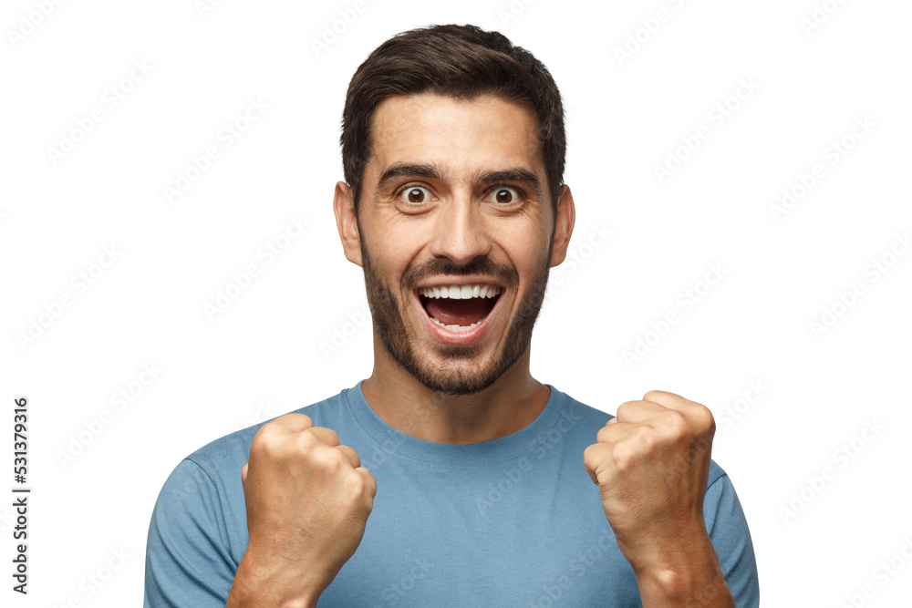 Passionate soccer fan. Young attractive man in casual tshirt shouting while his team win, raised both fist in victory gesture Passionate soccer fan. Young attractive man in casual tshirt shouting while his team win, raised both fist in victory gesture