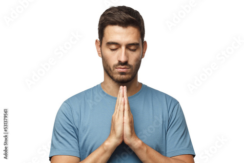 Canvas Print Closeup of young man putting hands together as if he is praying with closed eyes