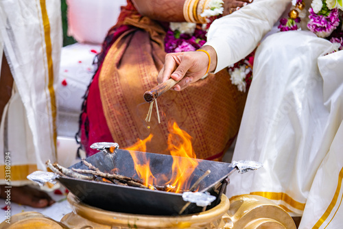 South Indian Tamil couple's wedding ceremony ritual items and hands close up