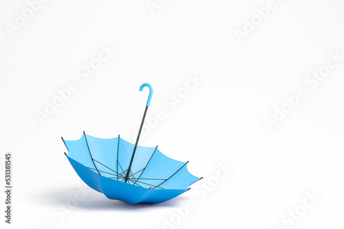 Blue umbrella upside down on blank copy space background photo