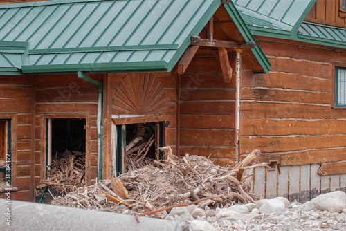 Total loss of house filled with rubble, debris, wood, sticks and tree branches due to river overflowing its banks and flooding the town of Red Lodge, MT with devastation and many insurance claims