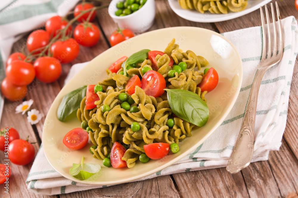 Fusilli pasta with cherry tomatoes and peas. Fusilli pasta with cherry tomatoes and peas.