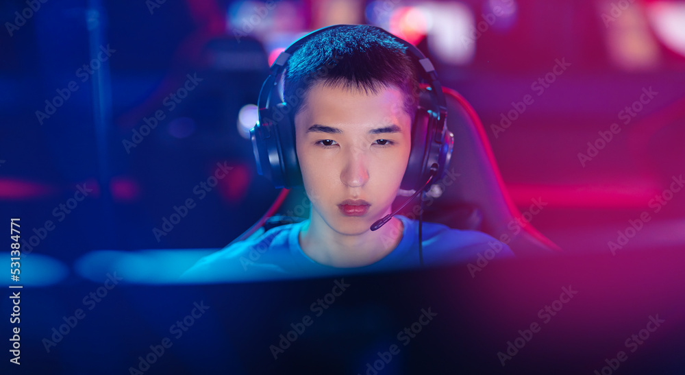 Fototapeta premium Beauty Young asian man pro gamer streamer playing in online video game, neon color soft focus. Concept banner cyber esport
