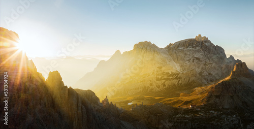 Canvastavla View from above, stunning aerial view of a mountain range during a beautiful sunrise with a mountain hut in the distance