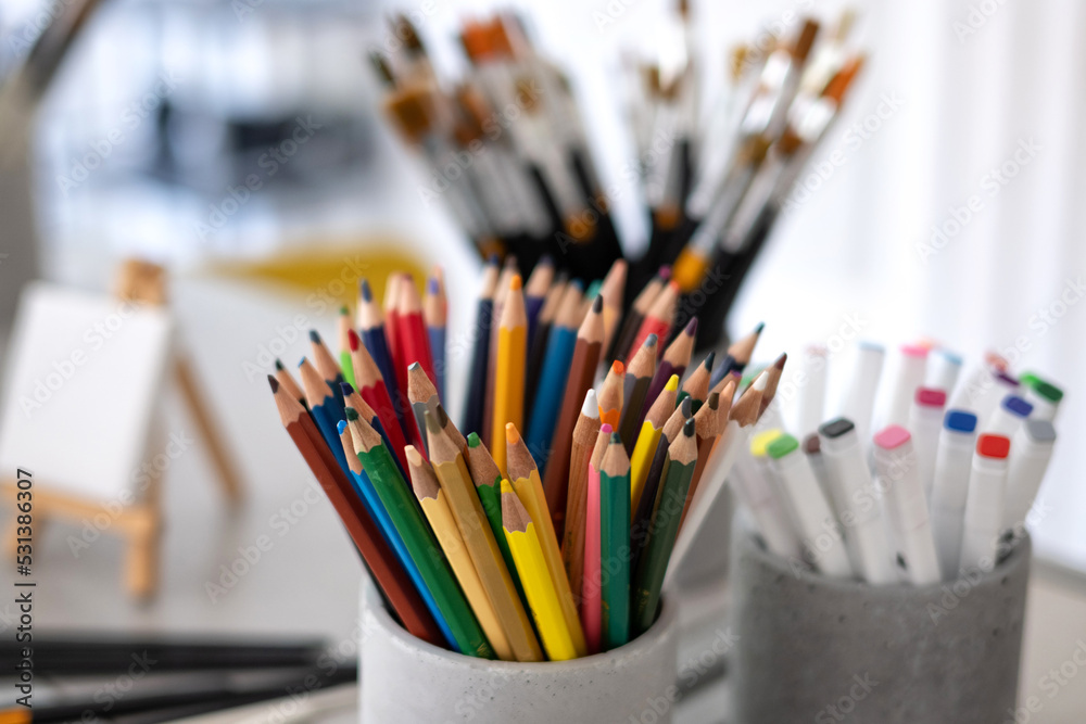 A set of tools of the artist, creator, colored pencils, brushes, artistic creative studio A set of tools of the artist, creator, colored pencils, brushes, artistic creative studio