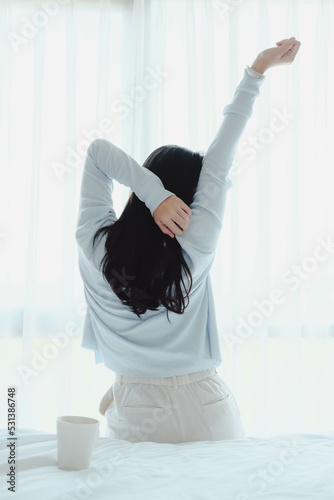 woman doing exercise after wake up with coffee mug