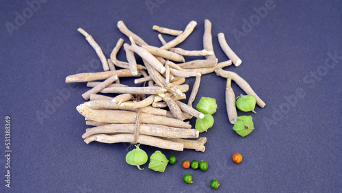 Ashwagandha Dry Root Medicinal Herb with Fresh Leaves, also known as Withania Somnifera, Ashwagandha, Indian Ginseng, Poison Gooseberry, or Winter Cherry. 