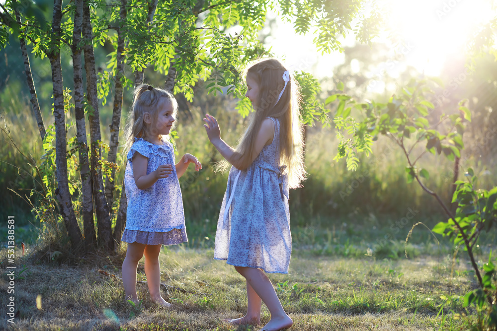 Fototapeta premium Children walk in the summer in nature. Child on a sunny spring morning in the park. Traveling with children.