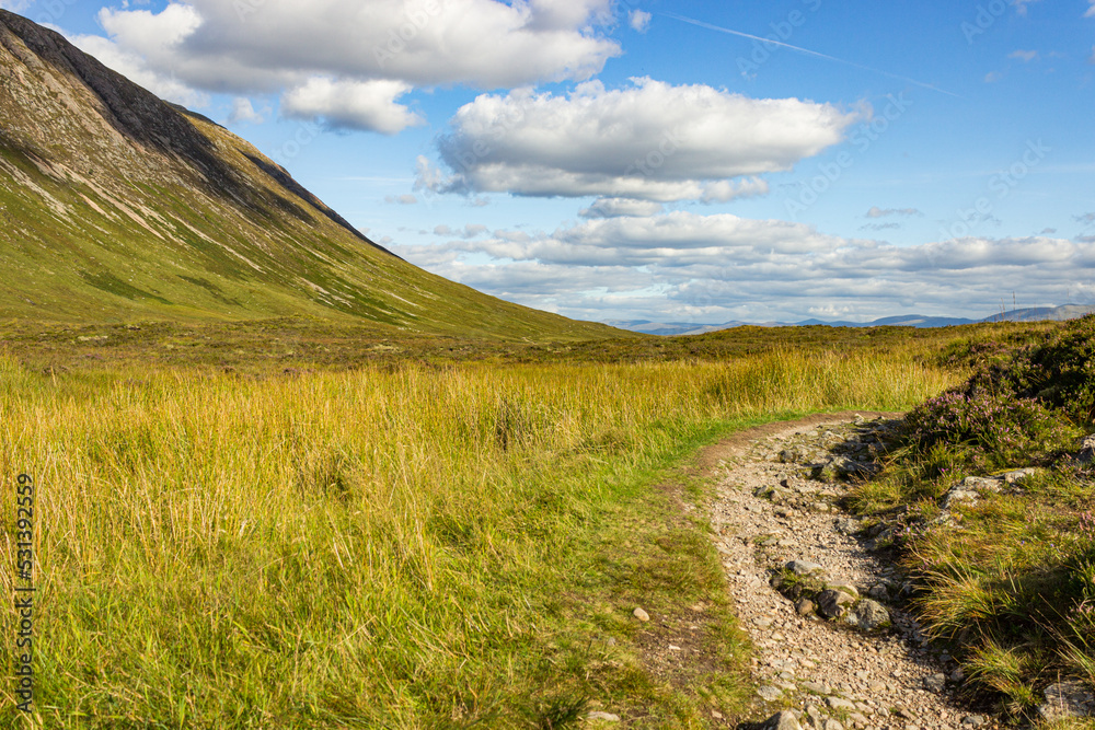 Hiking trail at Glen Coe on a beautiful summer day, start walking, Highlands, Scotland