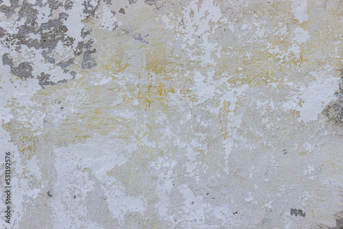 Very damaged aged white plaster wall background texture with yellow stains