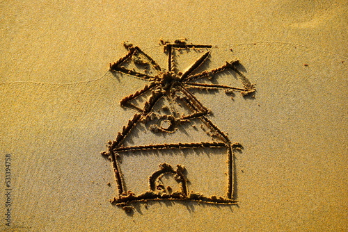 Windmill drawn on the beach sand photo