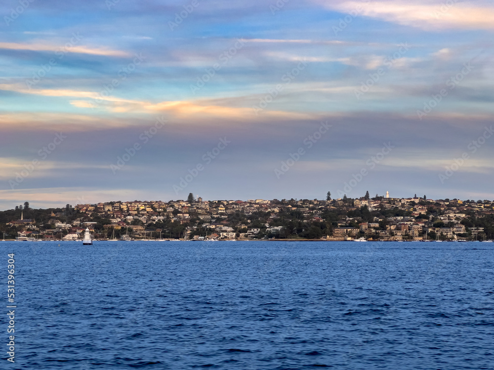 Sydney Harbour Australia at Sunset, lovely coloured skies boats ferries cruise liners houses and buildings 