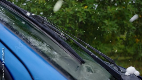 close-up of large hail falling during a ice storm on a car window