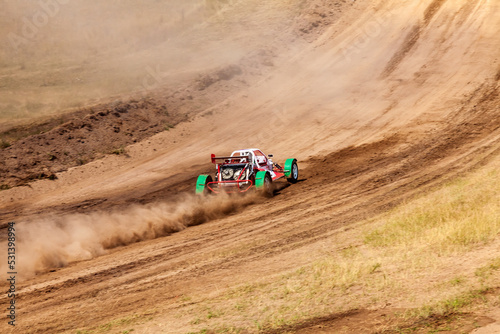 A small sports blurred buggy on a rally competition track during weekend training on a warm summer day. © Aleksandr Kondratov