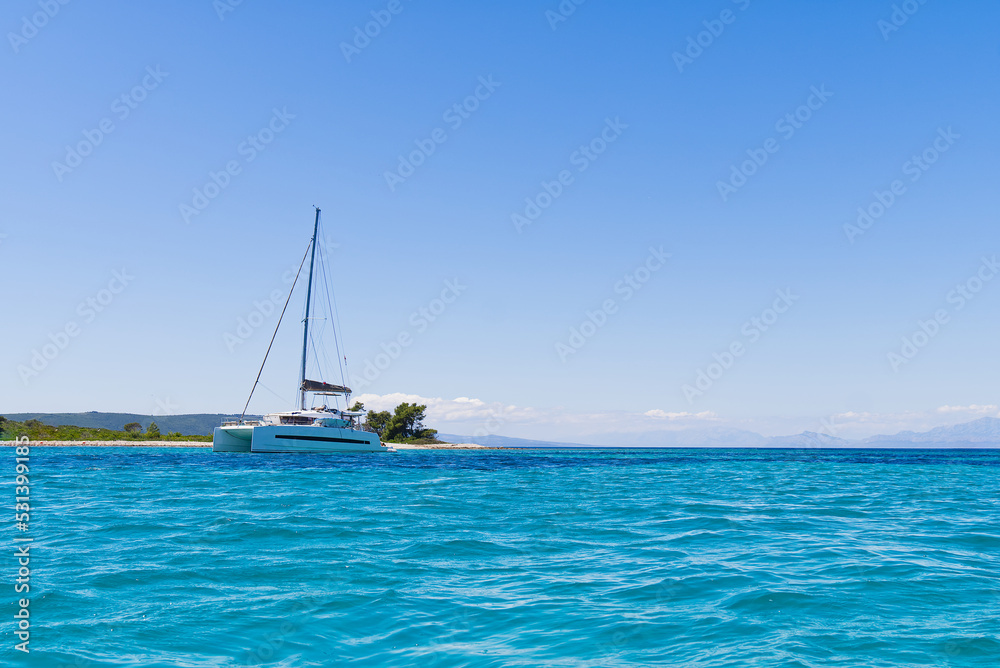 Catamaran sailing in ocean. paradise at sea. Blue sky and turquoise blue sea water. Mexican Caribbean beaches. Catamaran sailing in ocean. paradise at sea. Blue sky and turquoise blue sea water. Mexican Caribbean beaches.